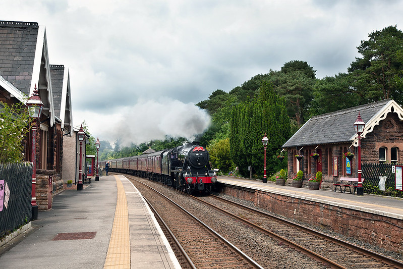 The delightfully maintained waiting shelter at Armathwaite Station is complemented by the well tended flora as 8F No.48151 passes through, heading the southbound Dalesman of Tuesday 25th June 2019.

This tour had been re-routed via Shap for the outward leg with steam coming on at Carnforth and on the return working right through to Preston, rather than Hellifield.