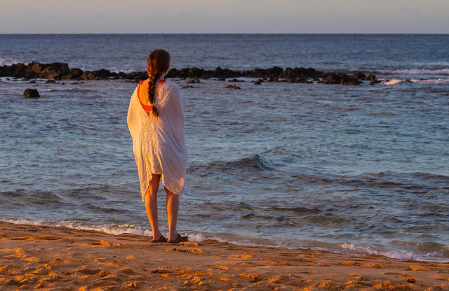 Girl on the bach, early morning, Kauai, Hawaii