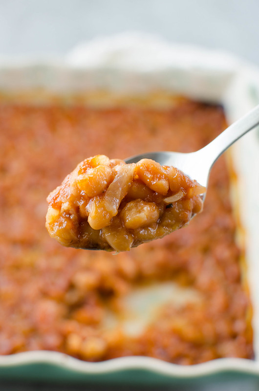 Pineapple Baked Beans - a favorite side dish for BBQs! Beans with bacon, crushed pineapple, and brown sugar are baked until the sauce is thick and delicious.