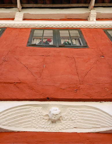 A red wall with a plaster angel in Trelleborg, Sweden