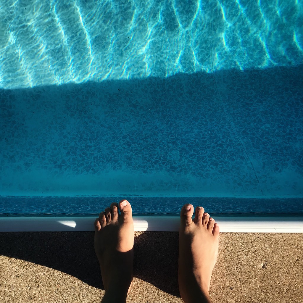 Feet by the side of the pool