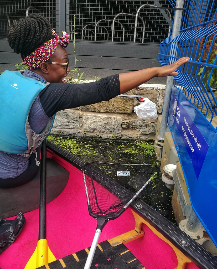 Reaching for plastic litter in the Hackney Wick canals