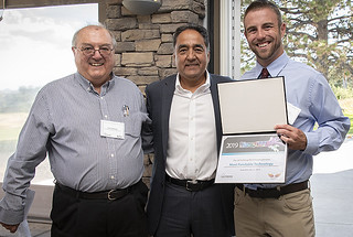 Derrick Kaseman (right) receives his award for Most Fundable Technology from Antonio Redondo (left), director of the Richard P. Feynman Center for Innovation, and John Chavez (center), president of New Mexico Angels. 