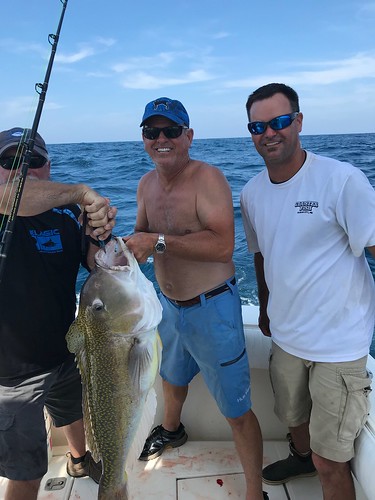 Photo of men on a boat with a golden tilefish