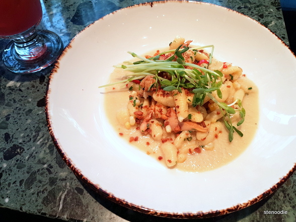 Cavatelli with chanterelle, smoked corn sugo, and pea shoots