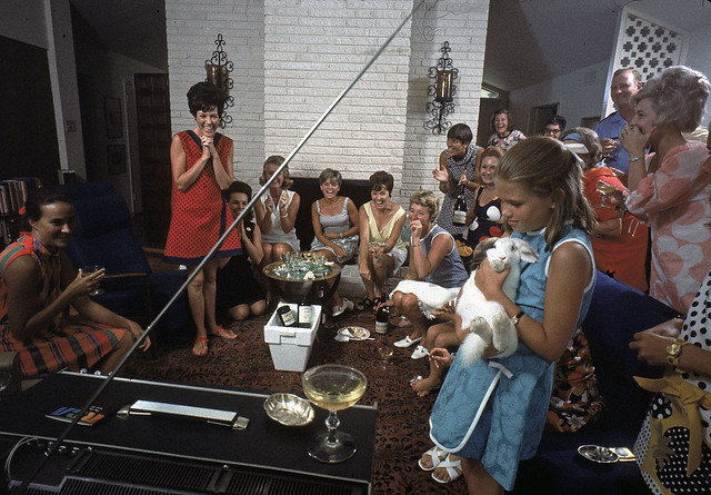 40.  In Texas, Pat Collins (in red), the wife of the Apollo 11 astronaut Mike Collins, celebrates while watching the splashdown and the successful end of the mission with a houseful of friends.