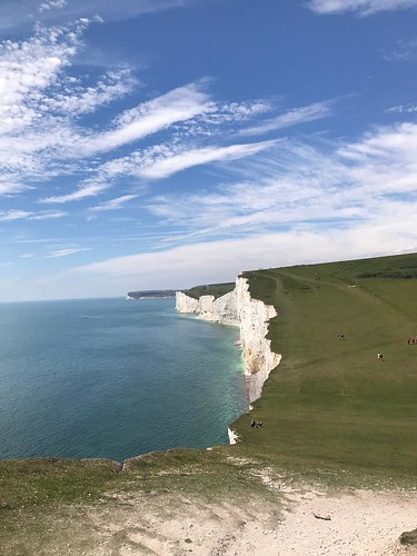 The white Seven Sisters cliffs framing blue sea with blue … | Flickr