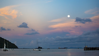 Sun sets while moon rises, Phuket, Thailand