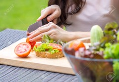 Young beautiful asian woman cooking sandwich with clean food vegetables and fruits for good healthy over green background, healthy food woman for diet