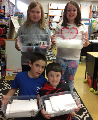 Makerspace - kids pose with new supplies