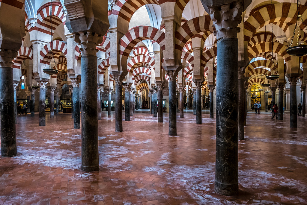 Columns and double stripped arches Mosque-Cathedral Cordoba, shown from a differing angle; strong resemblance to a fun house. 