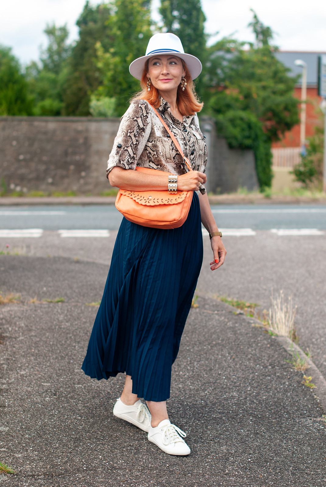 Why a Pleated Maxi With Sneaks is a Failsafe Summer Outfit \ snakeskin print shirt \ navy pleated maxi skirt \ white fedora \ white sneaks \ orange shoulder bag | Not Dressed As Lamb, over 40 fashion