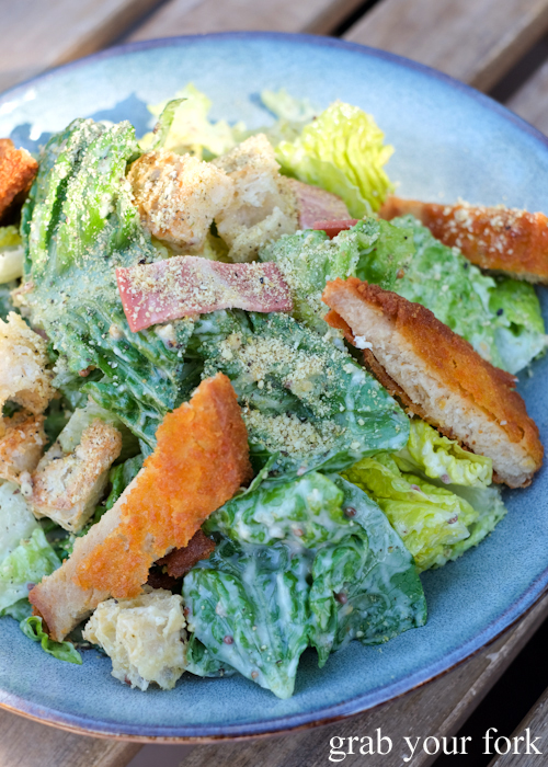 Vegan Caesar salad with plant-based schnitzel at Gardeners Lodge vegan cafe in Camperdown Sydney
