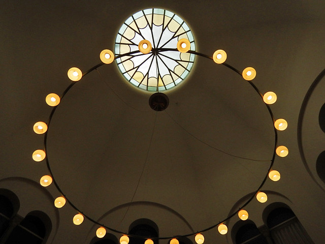 A ring of lights and a circle of stained glass in the old section of the main library in Copenhagen, Denmark