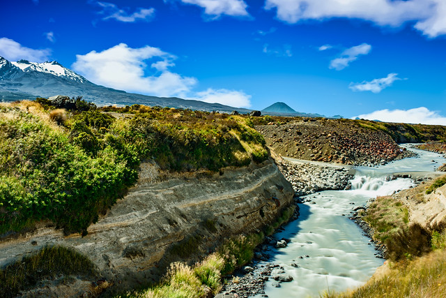 Fast flowing rapids in the central plateau with volcanos in the background