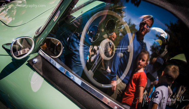Spectators reflected, vintage Porsche at Monterey car week