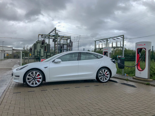 Supercharger charging station for electric cars: Tesla Model 3 with Long-Range-Batterie charges at the electric filling station in Erftstadt, Germany