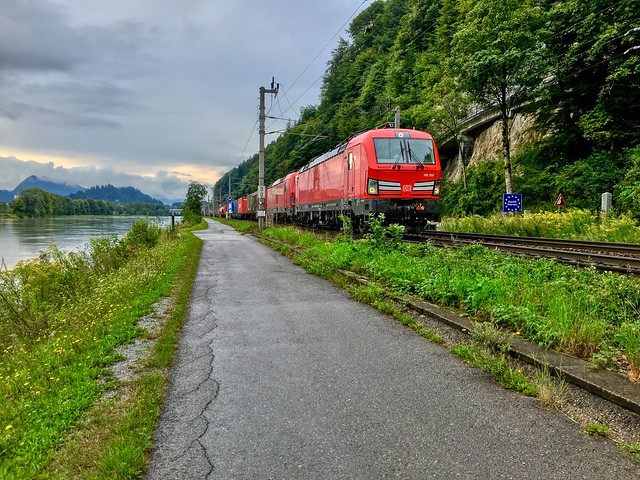 Deutsche Bahn freight train passing the river Inn between Kufstein, Tyrol, Austria and Kiefersfelden, Bavaria, Germany