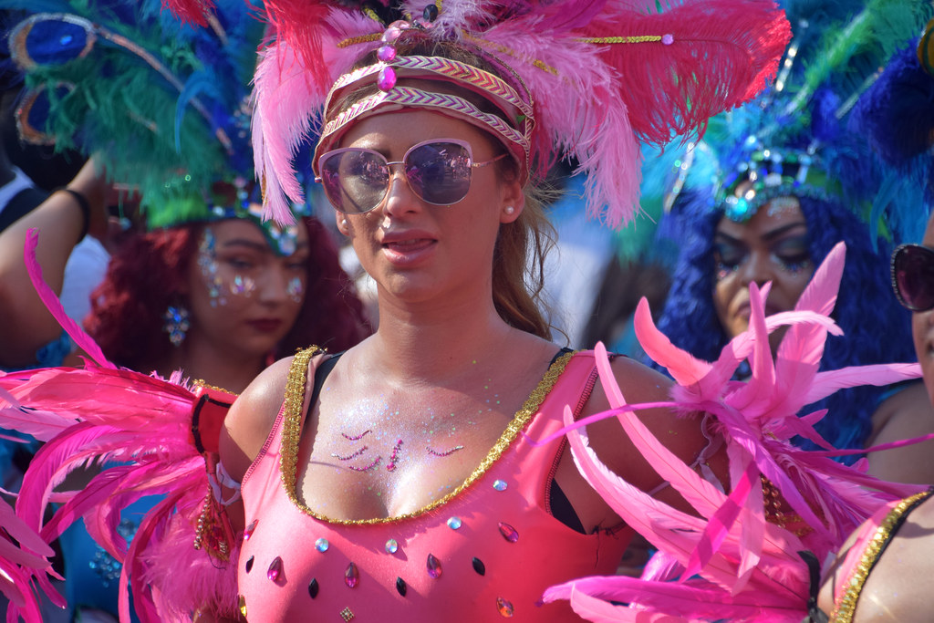 DSC_5894 Notting Hill Caribbean Carnival London Mas Players Parade Participant Performer Exotic Colourful Pink Showgirl Costume with Sun Glasses and Ostrich Feather Headdress August 26 2019 Beautiful Stunning Girls