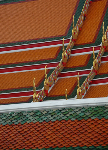Unusual red roof tiles on a temple in Bangkok, Thailand