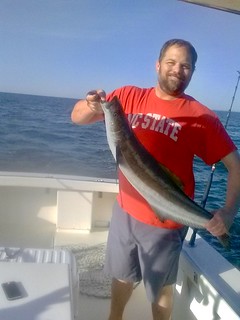 Photo of man holding a cobia.