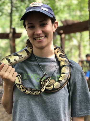 A girl holds a snake.