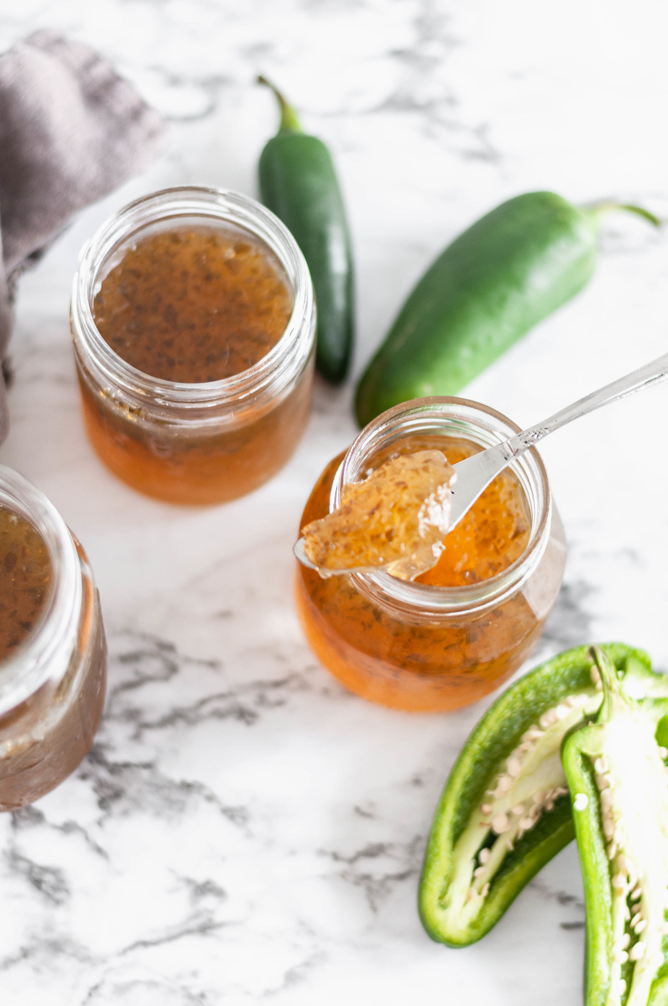 Homemade Jalapeno Jelly is easier than you would think and so delicious on all the things. Slather it on hot cornbread, a juicy burger or use it as a dip.