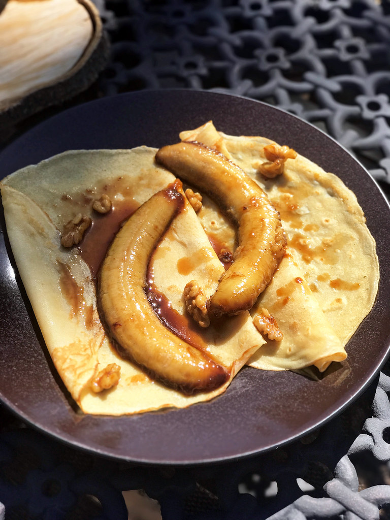 Crepes with caramelized bananas, whiskey, and walnuts