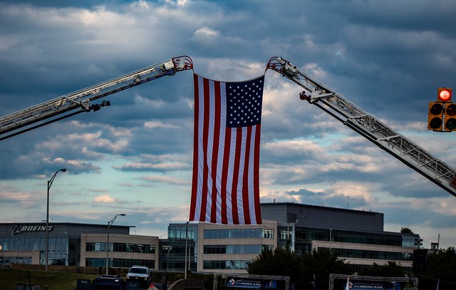American Flag flying being held up by the Arlington Fire Department ladder