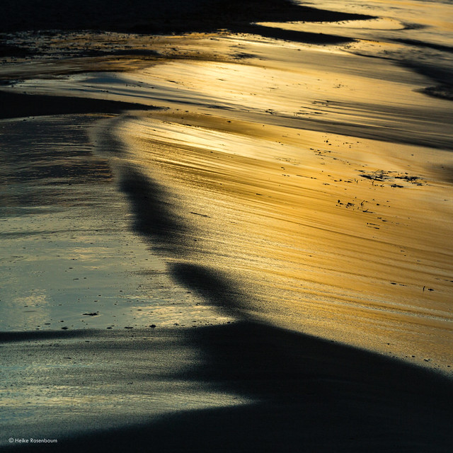 Water, sand and the setting sun