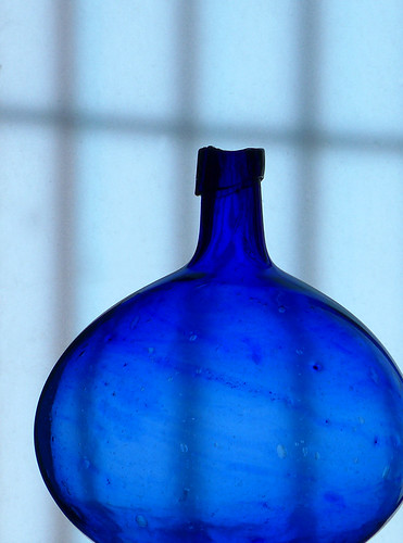 A back-lit blue glass vase in an art gallery in Puebla, Mexico