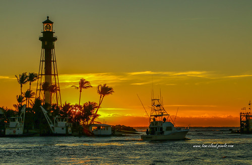 Sportfisher and Lighthouse by tclaud2002, A sport fishing boat plies the waters of the Hillsboro Inlet near the lighthouse at Hillsboro Beach,