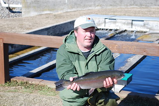 Photo of  man holding a rainbow trout.