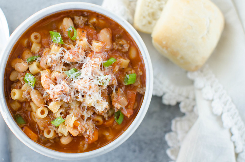 Pasta Fagioli - Olive Garden copycat recipe. This hearty soup is filled with spicy Italian sausage, veggies, pasta, and beans and topped with fresh shredded Parmesan cheese. It is serious comfort food that the whole family will love!