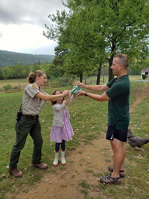 Ranger Laura and visitors release an adult monarch butterfly