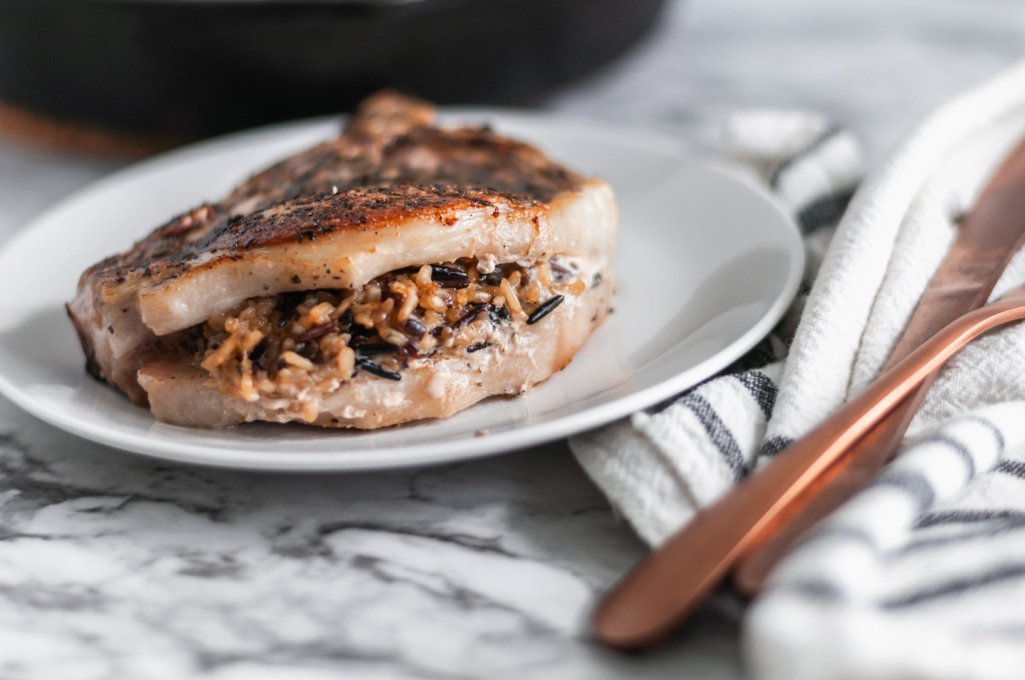 We're getting a little fancy here today but no worries, as always the recipe involves just a handful of easy to find ingredients. These Stuffed Pork Chops with Wild Rice are easy enough for a weeknights but dressed up enough for guests.