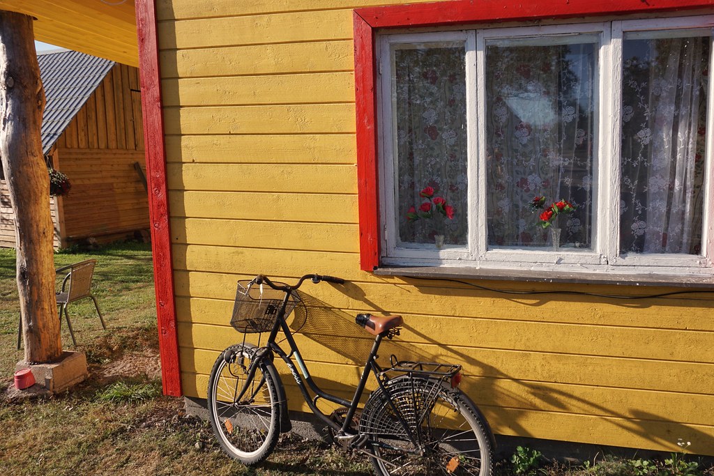 A bike against a yellow panelled house in Kihnu Island, Estonia