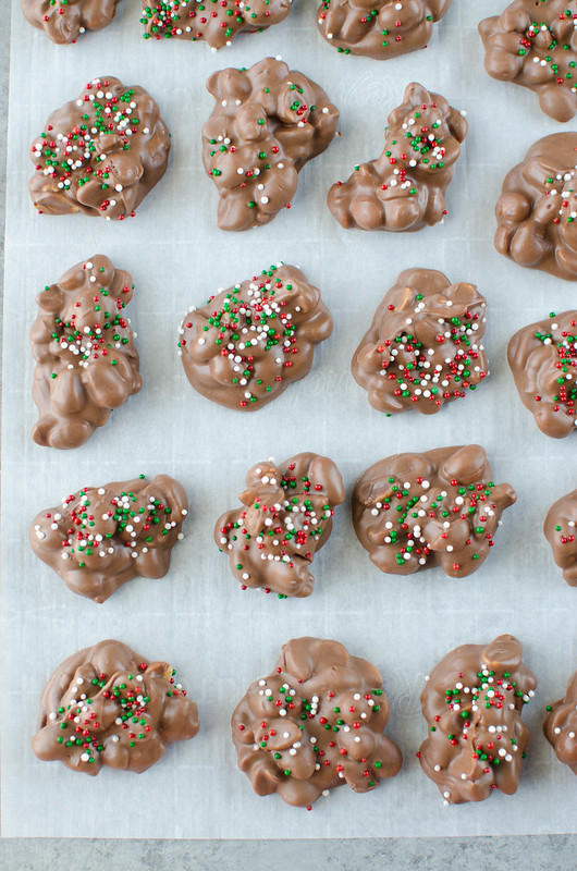 Crockpot Candy is a must make for the holiday season! It's like chocolate covered peanuts but better! Only 4 ingredients and made completely in the slow cooker. It makes a ton so it is perfect for cookie tins or holiday parties!