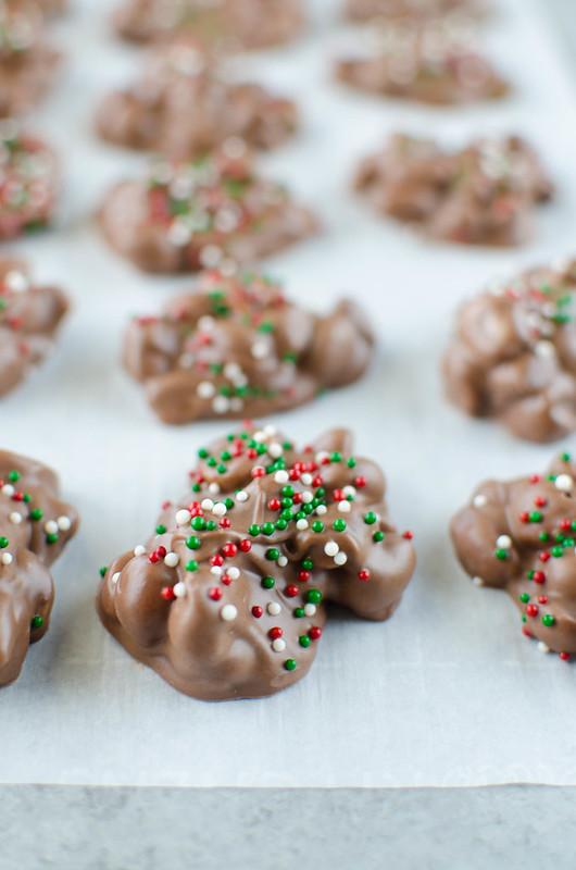 Crockpot Candy is a must make for the holiday season! It's like chocolate covered peanuts but better! Only 4 ingredients and made completely in the slow cooker. It makes a ton so it is perfect for cookie tins or holiday parties!