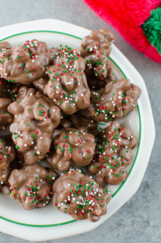 Crockpot Candy is a must make for the holiday season! It's like chocolate covered peanuts but better! Only 4 ingredients and made completely in the slow cooker. It makes a ton so it is perfect for cookie tins or holiday parties!