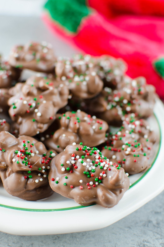 Crockpot Candy is a must make for the holiday season! It's like chocolate covered peanuts but better! Only 4 ingredients and made completely in the slow cooker. It makes a ton so it is perfect for cookie tins or holiday parties!