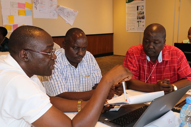Patrick Okori (ICRISAT; left), Chrispinus Rubanza (UDOM; center) and Ben Lukuyu (ILRI; right) in a discussion during the Africa RISING East and Southern Africa Project review and planning meeting held in Dar es Salaam, Tanzania on 10 – 11 September 2019.