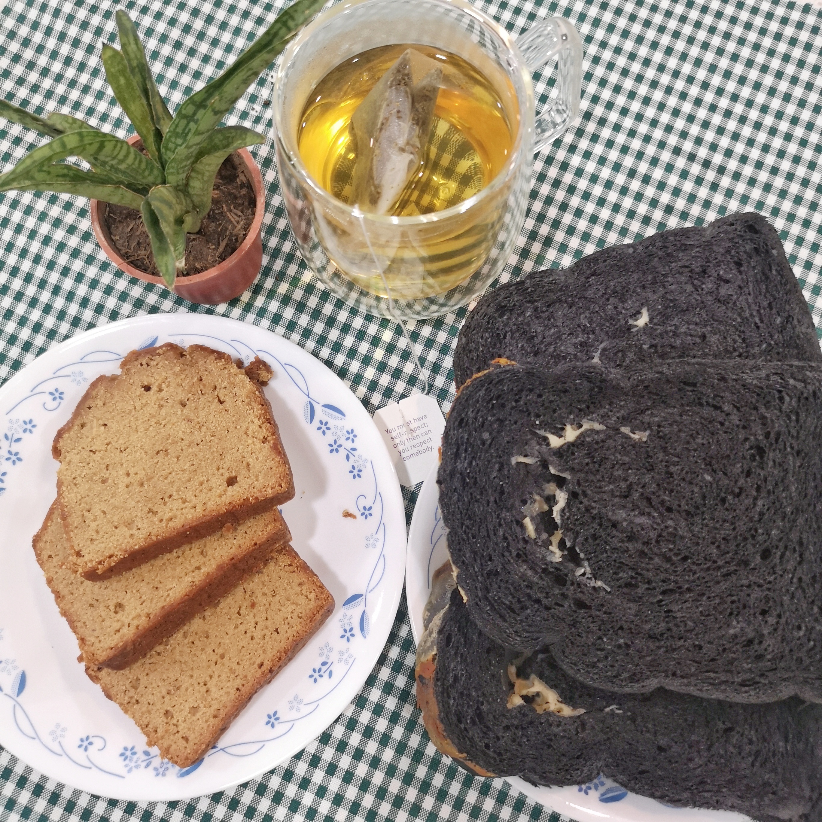 2 pieces of Cheesy Charcoal Almond Loaf (PhP 250), 2 pieces of Banana Saba Sourdough Loaf (PhP 200) and Green Tea with Kombucha
