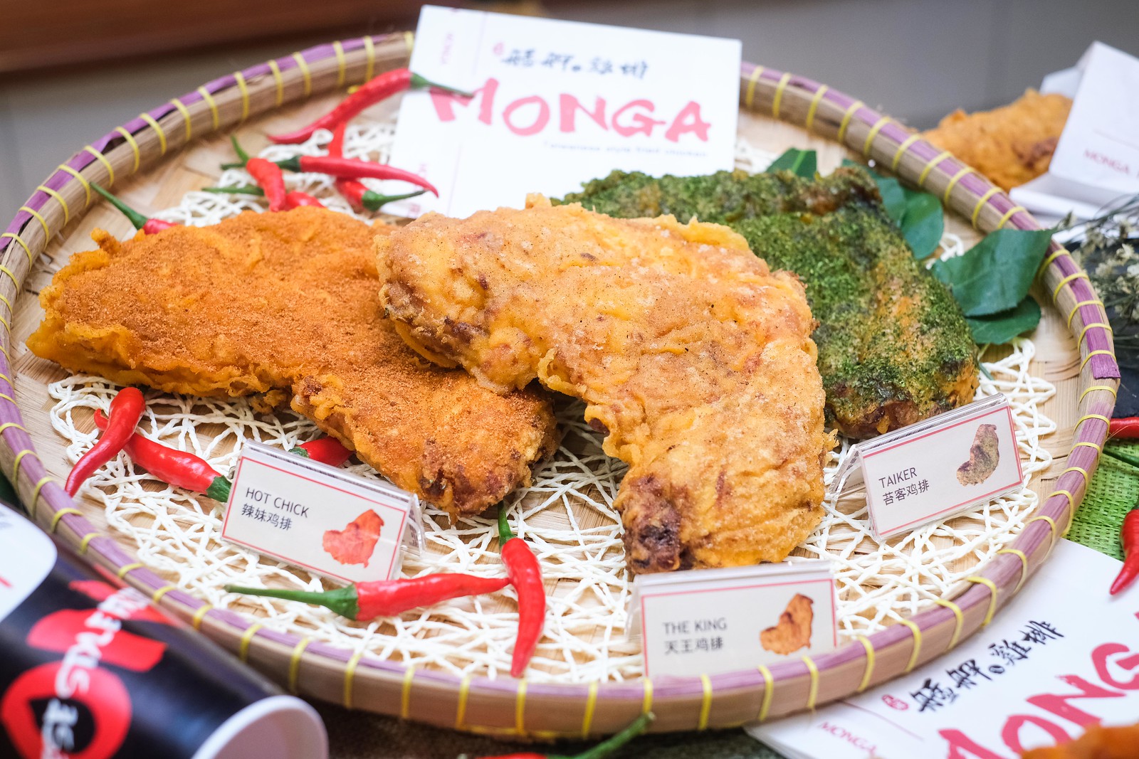 Three type of fried chicken on a woven tray