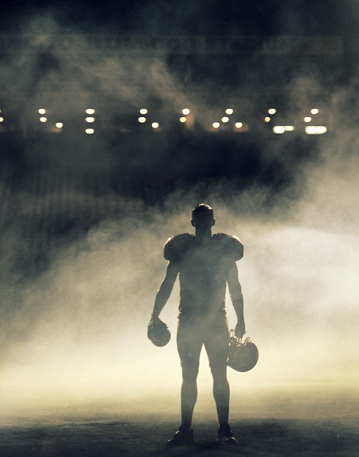 Football player o the field with fog