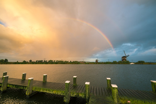 rainbow shower windmill mill lake water pier landscape sunset colors