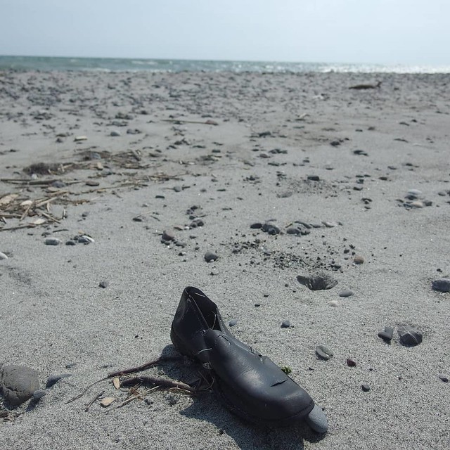 abandoned shoe on the shore