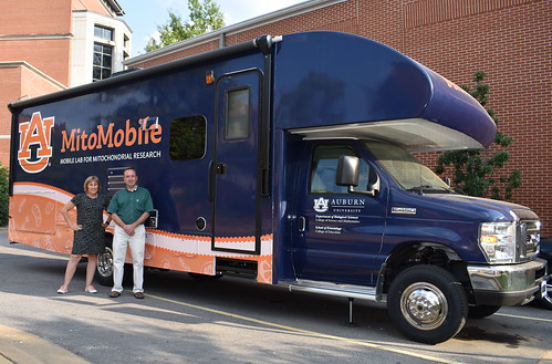 Professors Wendy Hood and Andreas Kavazis stand in front of the MitoMobile.