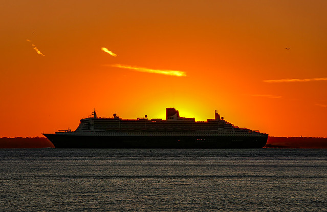 Queen Mary 2 sailing from New York at sunset