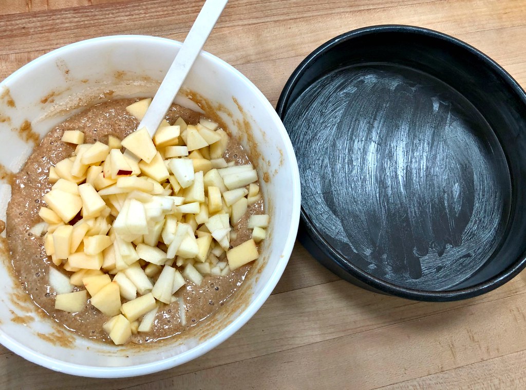 pour the apple batter into a greased pan